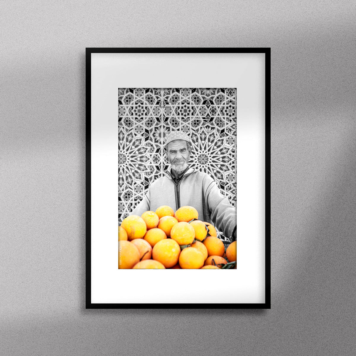 Tableau décoratif en noir et blanc d'un vieux marchand d'oranges très souriant, encadré dans un cadre noir - Format A3.